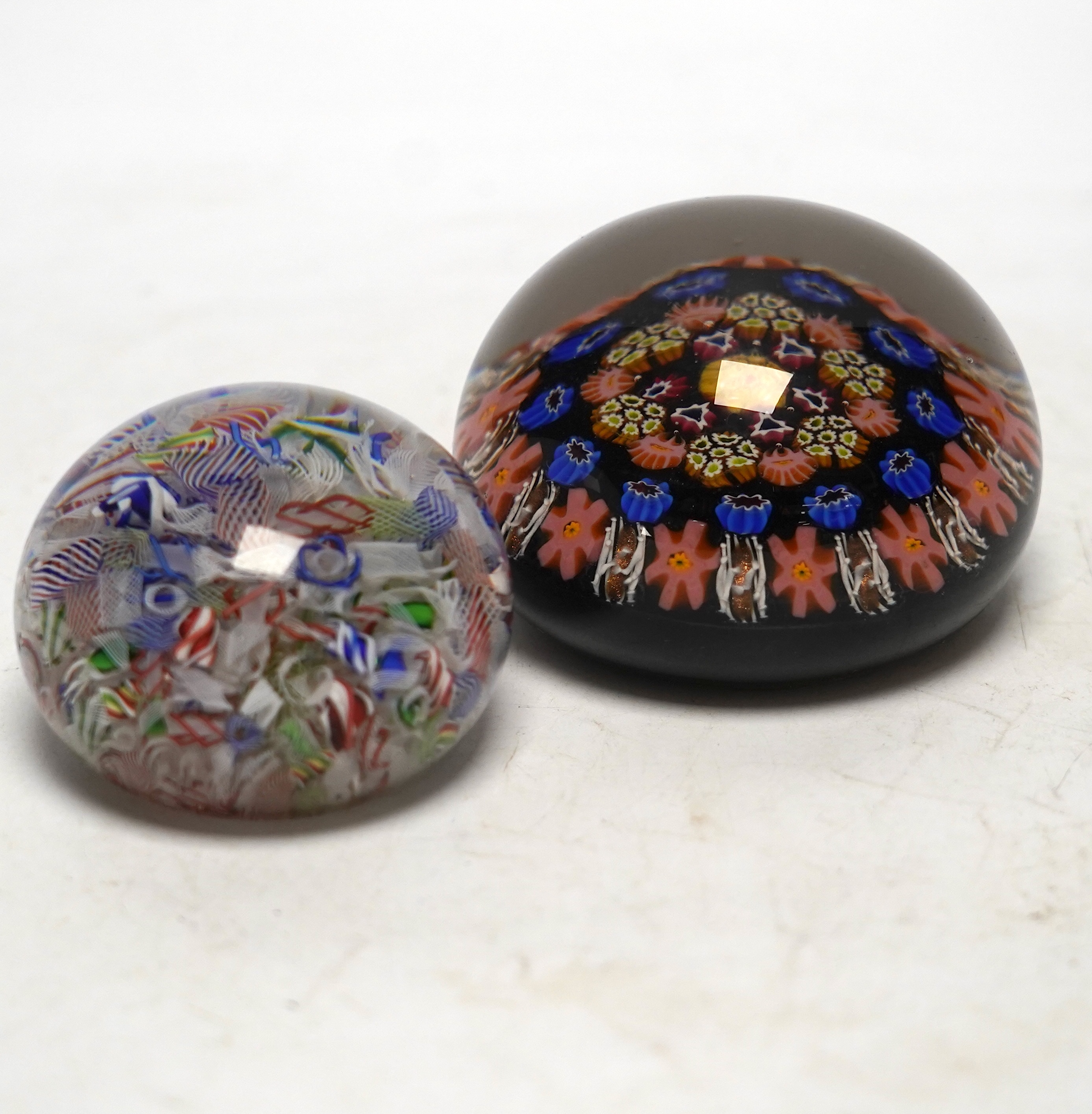 A mid 19th century French scattered cane paperweight and another, largest 8cm diameter